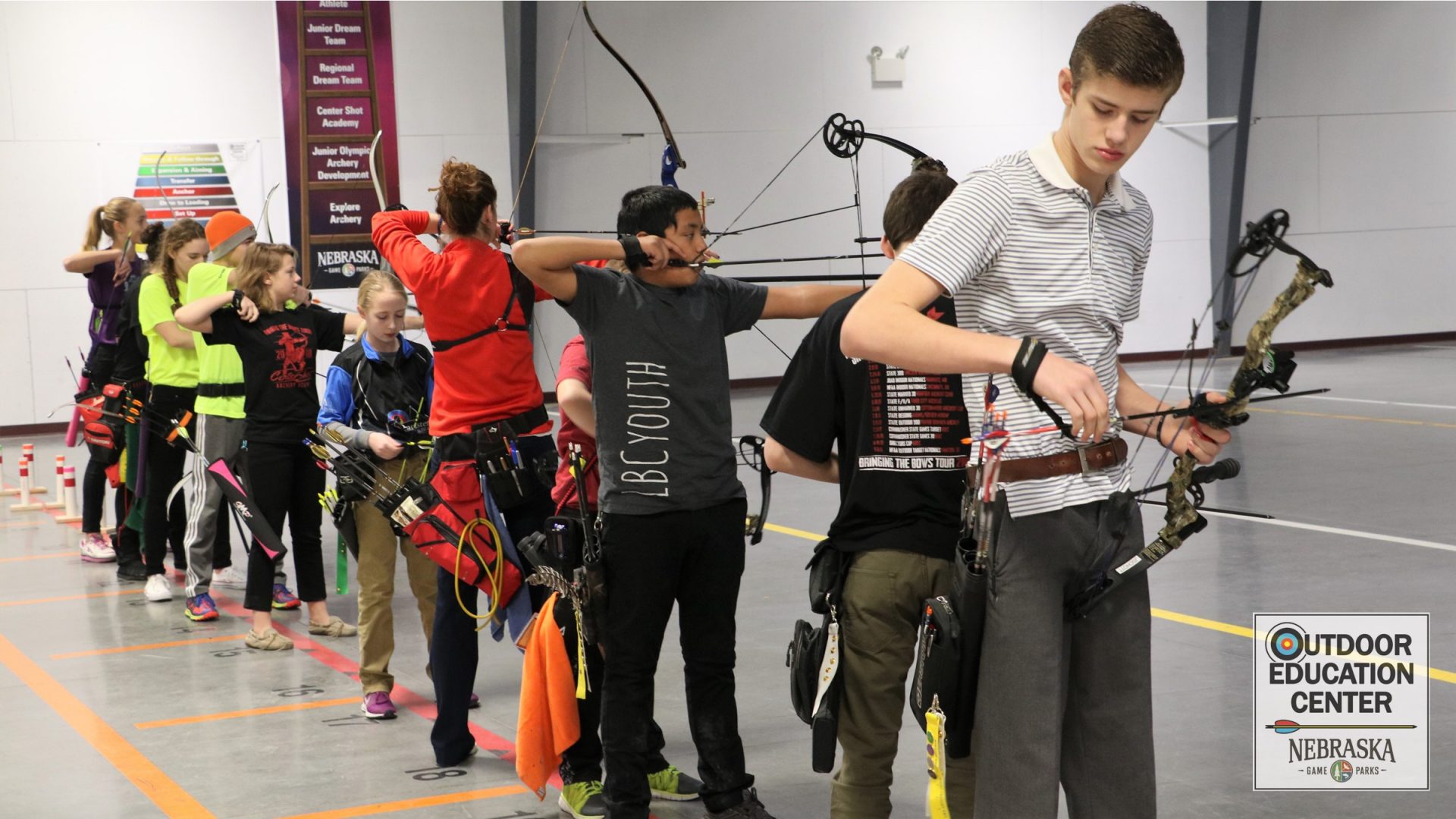 youth compound and recurve archers on the line