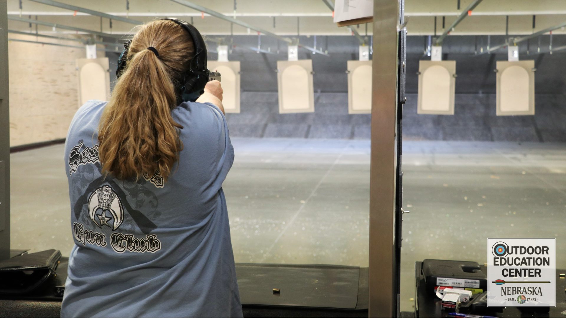 Competitor taking aim at row of large targets