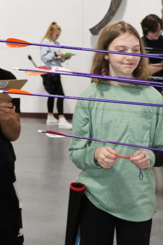 Two young archers scoring arrows