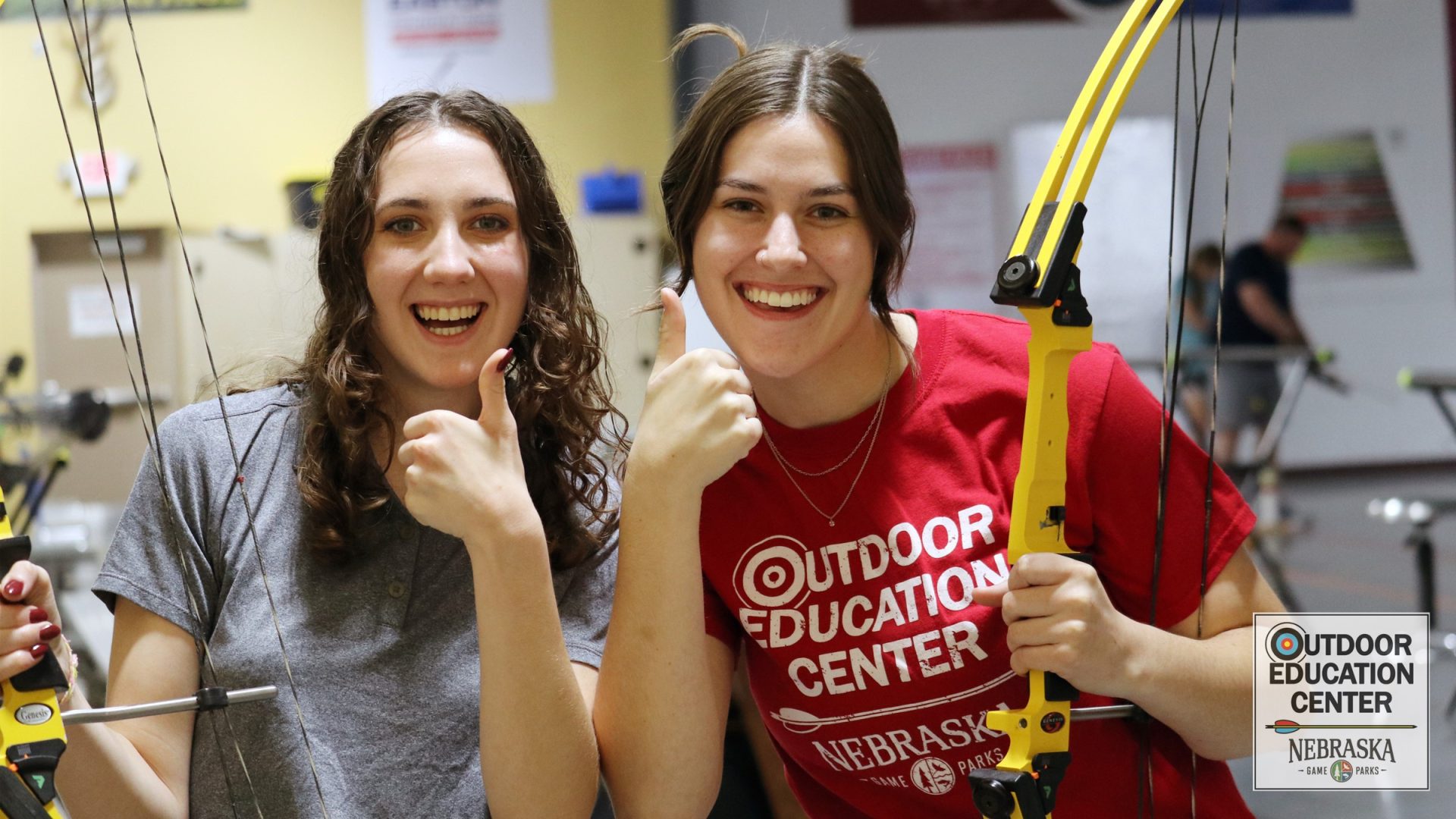 Two college students smiling with bows