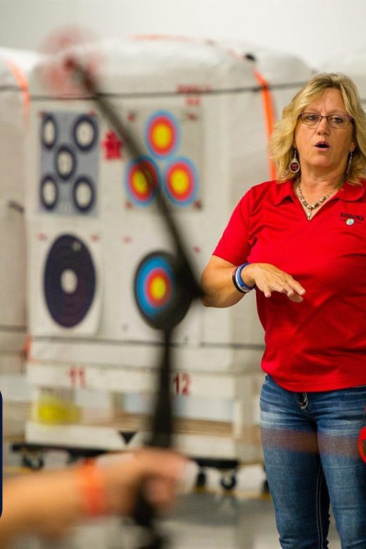 Instructor teaching archery