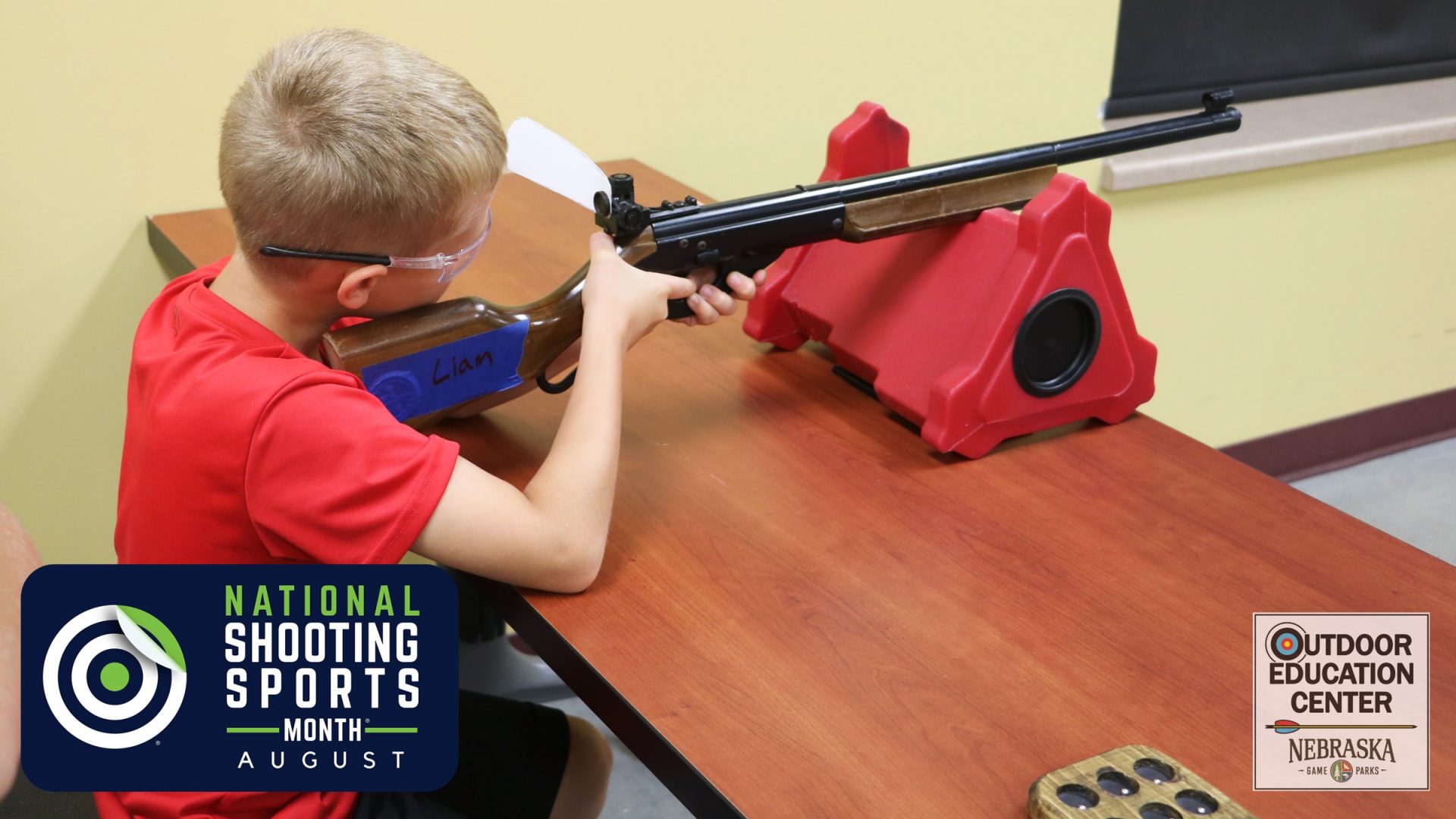 Youth using bench position to take accurate shot with BB gun