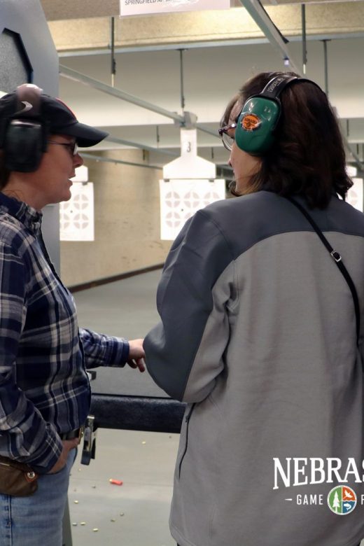 Instructor with student in the firearm range