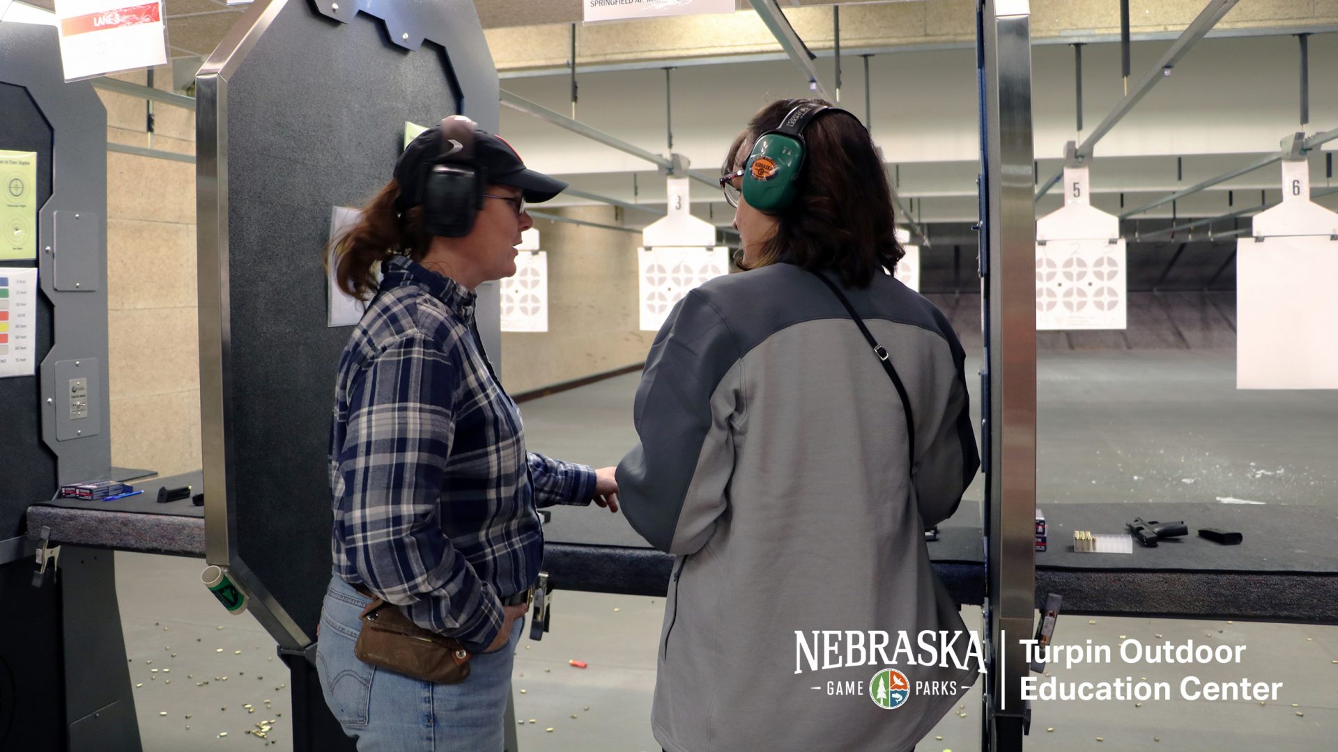 Instructor with student in the firearm range