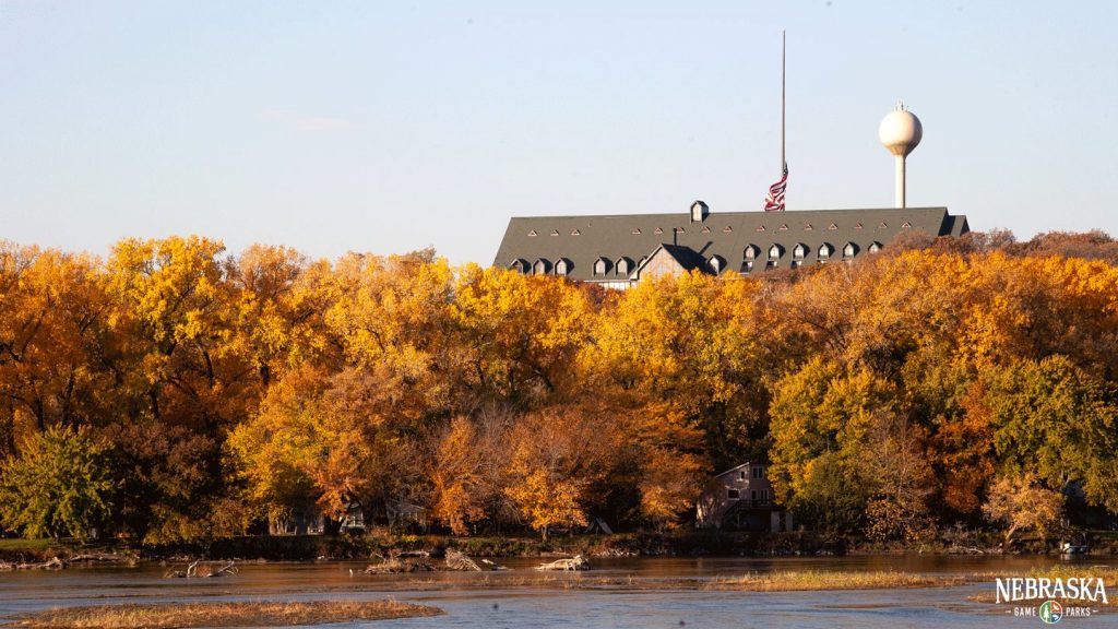 Autumn view from across the river of Peter Kiewit Lodge at Mahoney State Park