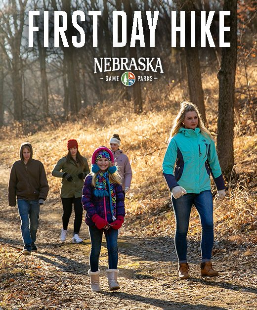 People hiking on a trail in a park during winter.