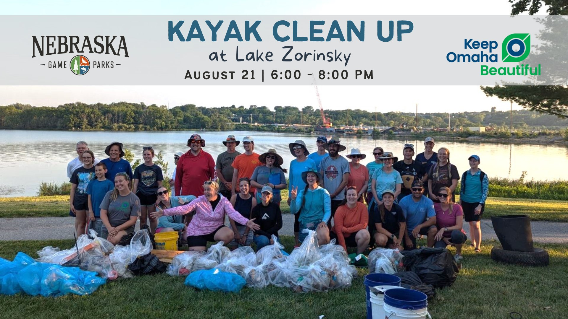 Group photo of people posing with trash collected during a kayak cleanup at an urban lake.