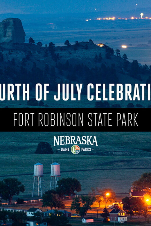 A view of Fort Robinson State Park and the nearby town of Crawford at night on July 4th with fireworks going off in the distance.