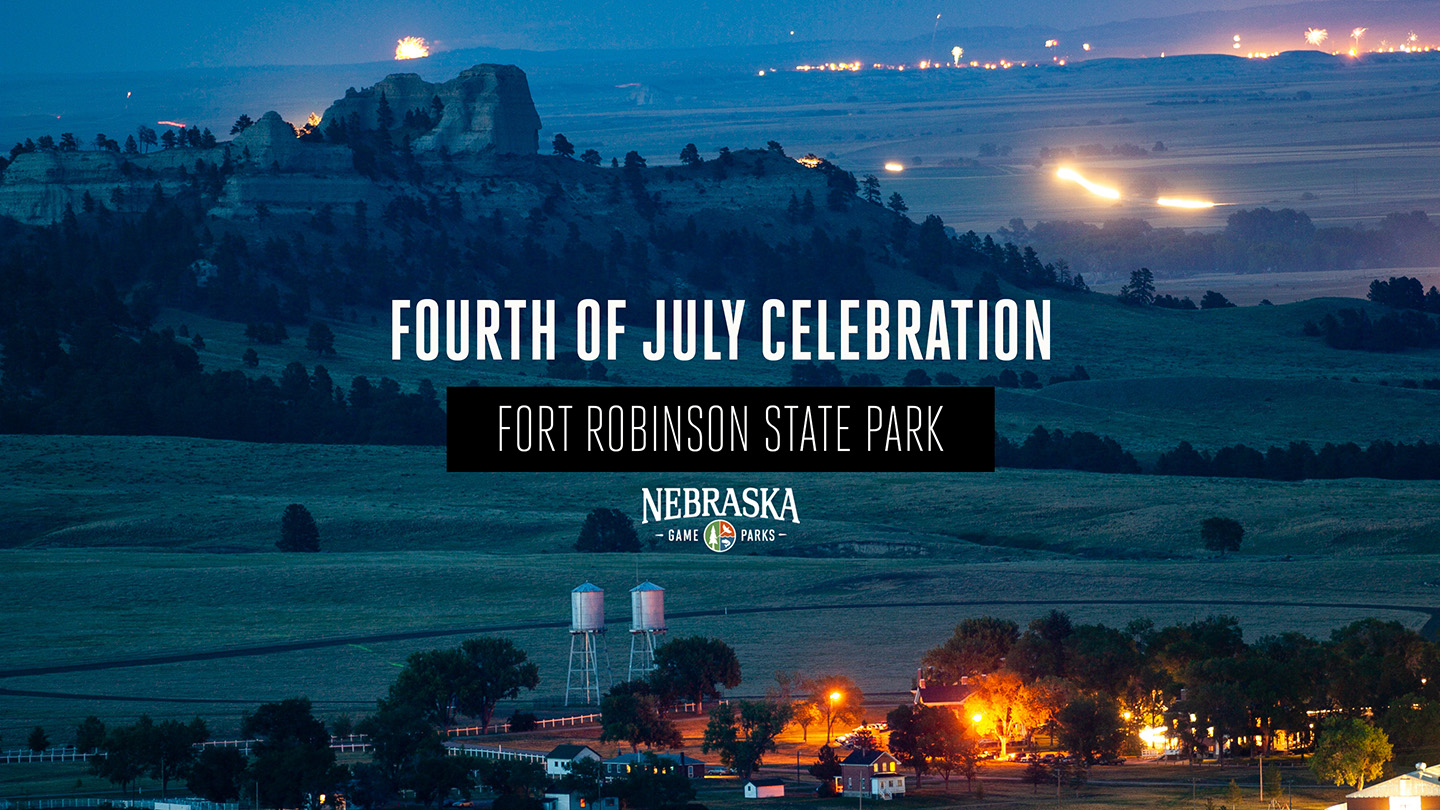 A view of Fort Robinson State Park and the nearby town of Crawford at night on July 4th with fireworks going off in the distance.