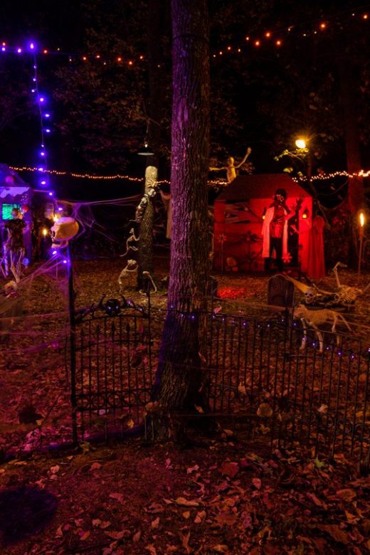 A spooky Halloween scene of a decorated campground at night.