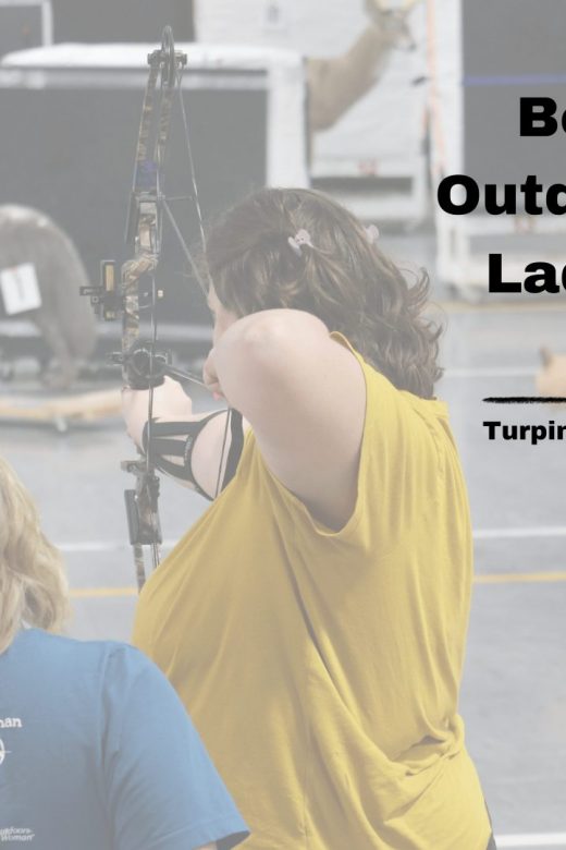 Women practice archery at the Turpin Outdoor Education Center's indoor range.