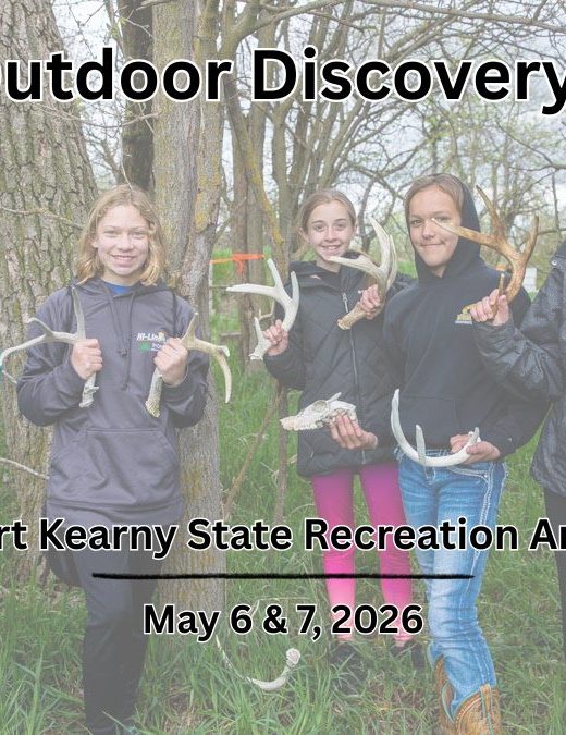 A group of school girls hold deer sheds outdoors.