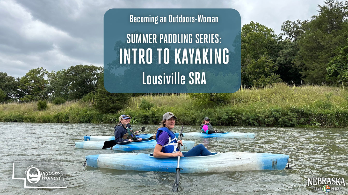 Women kayak on a river during spring.