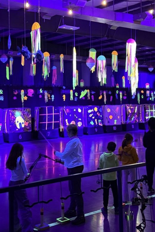People enjoy cosmic archery at the Turpin Outdoor Education Center.