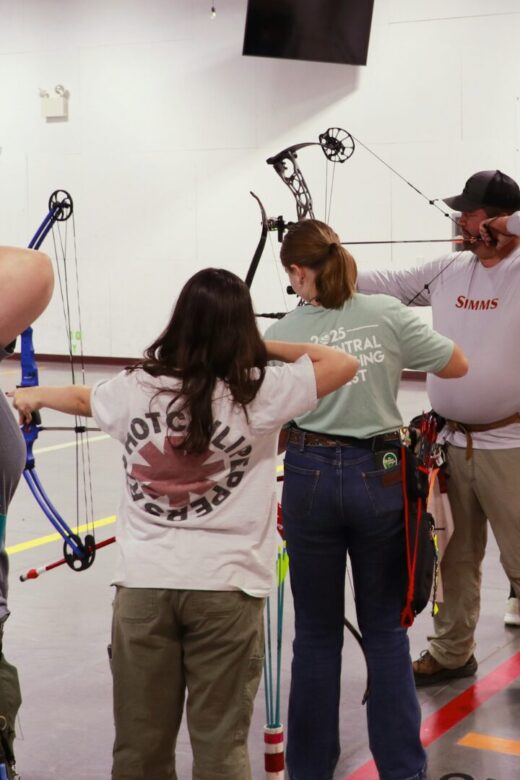 People shoot archery at the Turpin Outdoor Education Center.