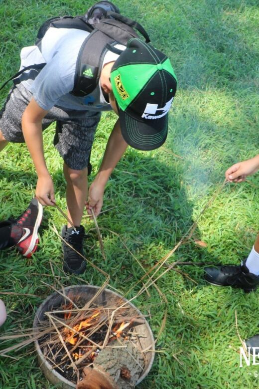 Picture of kids practicing survival skills outdoors.