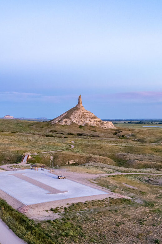 Aerial view of the parking lot and Walk to the Rock trail at Chimney Rock National Historic Site at dusk.