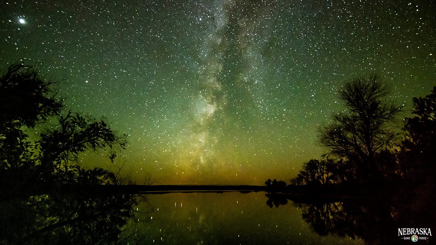 The Milky Way glows above Merritt Reservoir on a clear night.