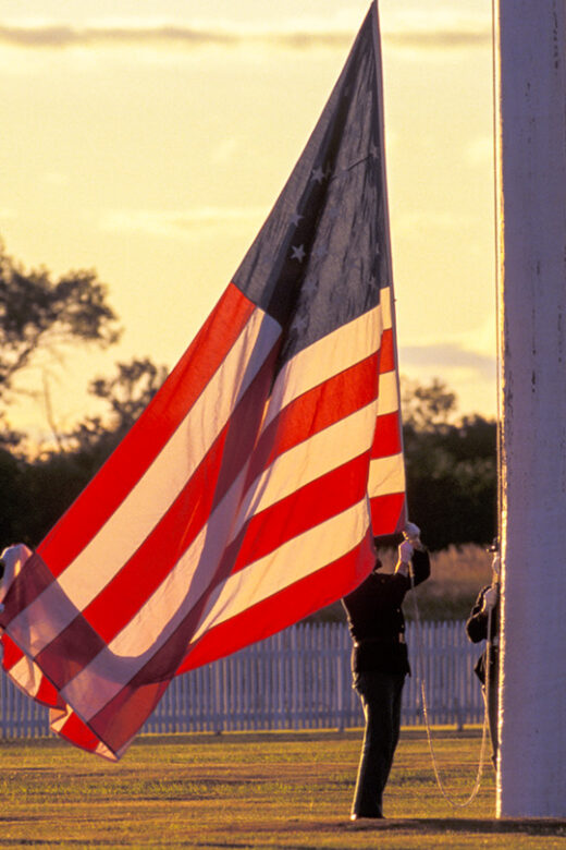 Historical reenactors raise an American flag at Fort Hartsuff State Historical Park.