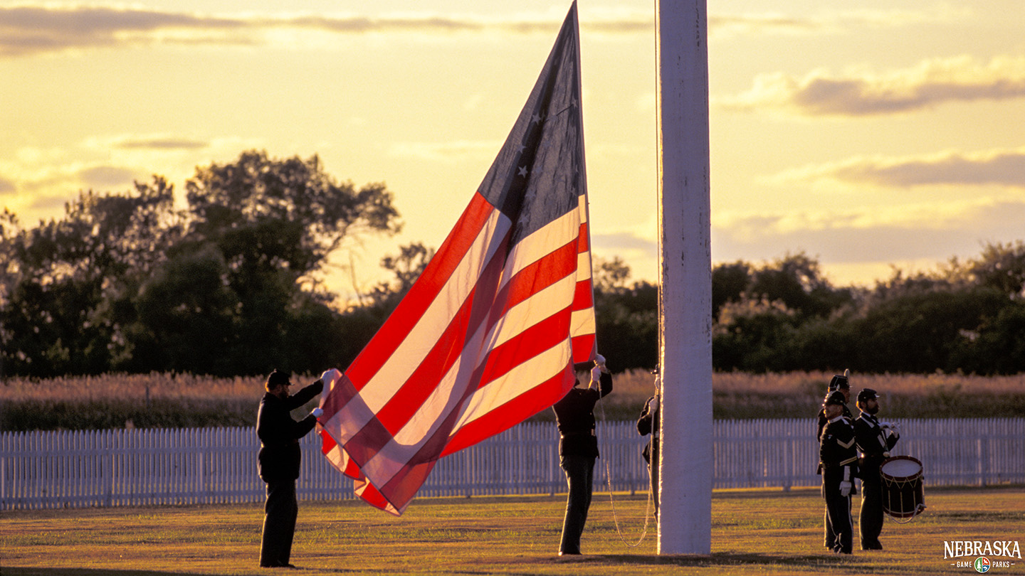 Historical reenactors raise an American flag at Fort Hartsuff State Historical Park.