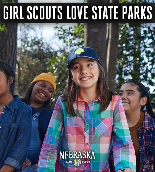 Four school girls hiking in a park.