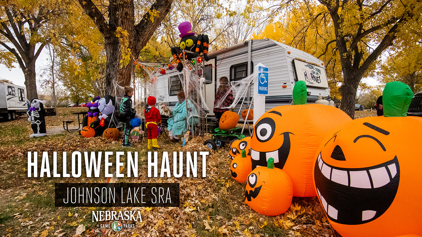 A campsite is decorated for Halloween in the fall as trick or treaters visit the camper.