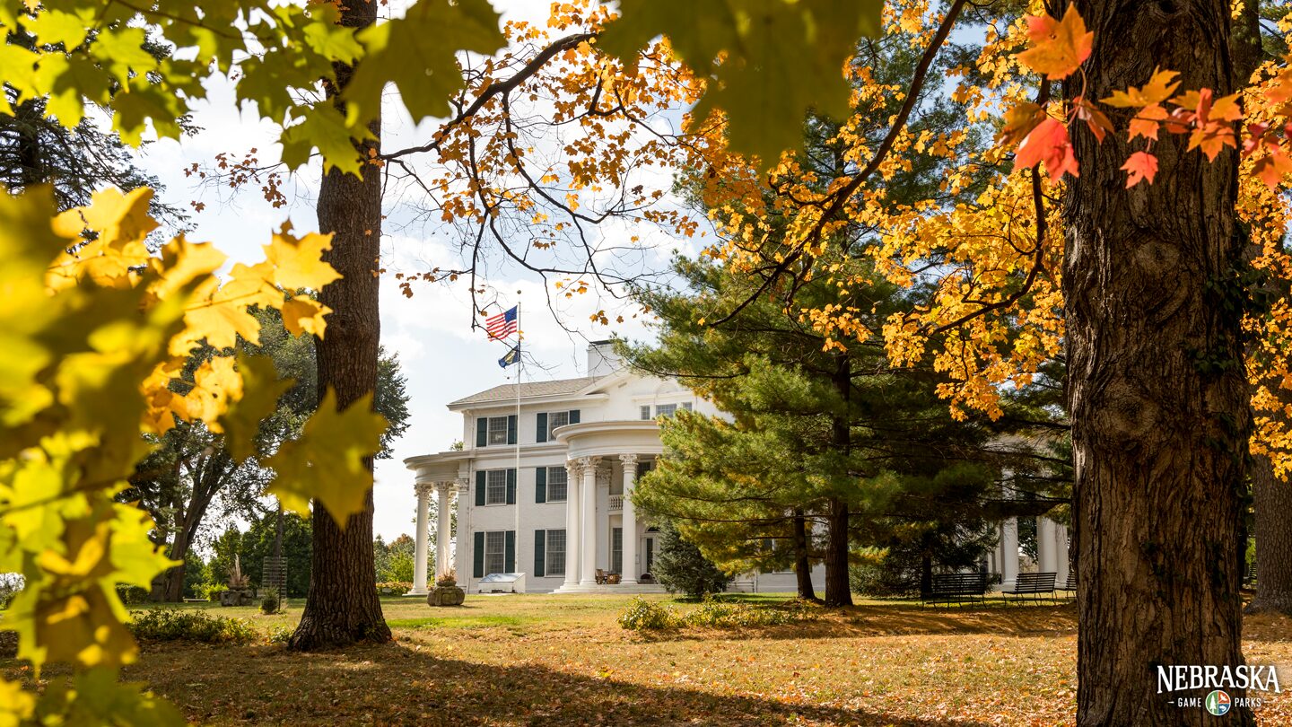 A view of Arbor Lodge Mansion in the fall through the trees.