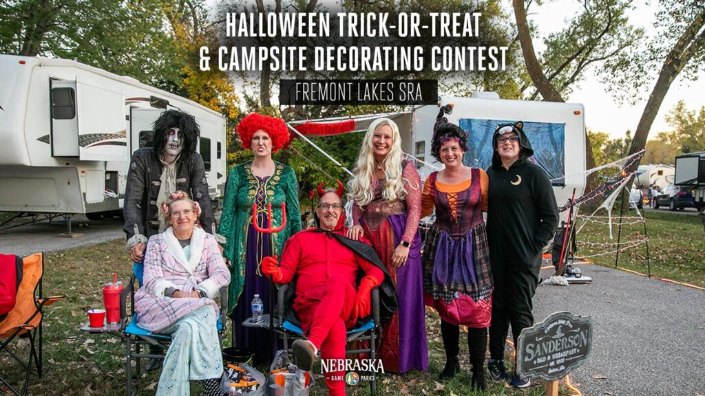 People dressed like the cast of Hocus Pocus pose for a photo at a state park.