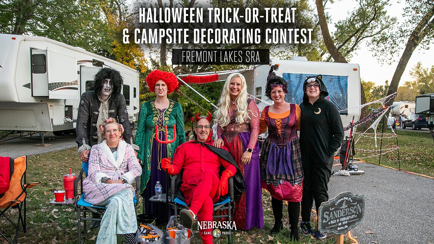 People dressed like the cast of Hocus Pocus pose for a photo at a state park.
