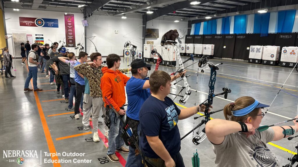 Archers shooting indoors